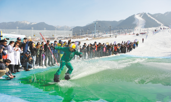 上图为3月24日，在丝绸之路国际度假区滑雪场，滑雪爱好者在体验雪地滑水。